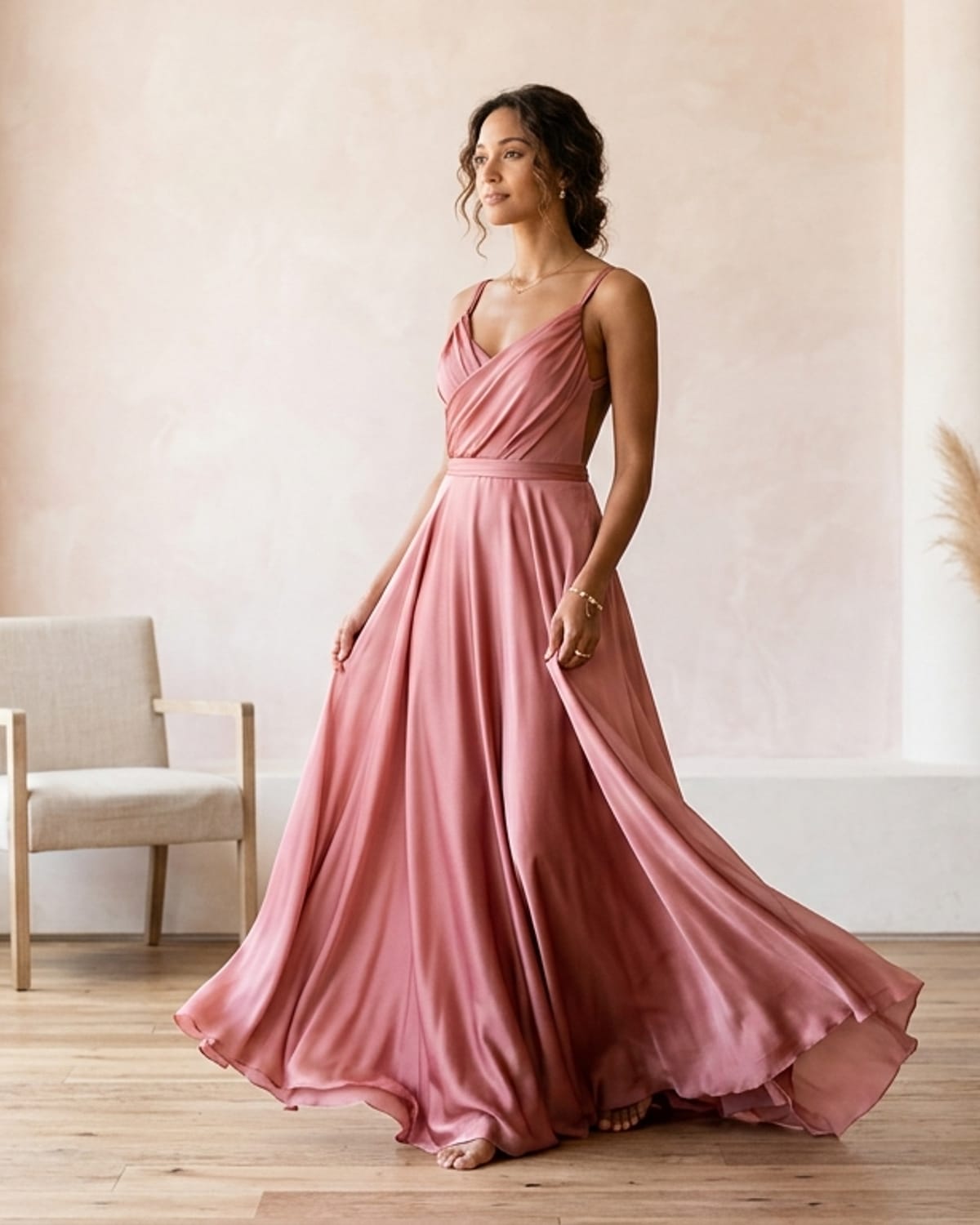 Model wearing a flowing rose-toned silk gown from the amorabrazil collection